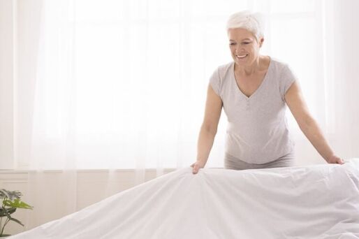 Senior woman cleaning and staging her home to sell.